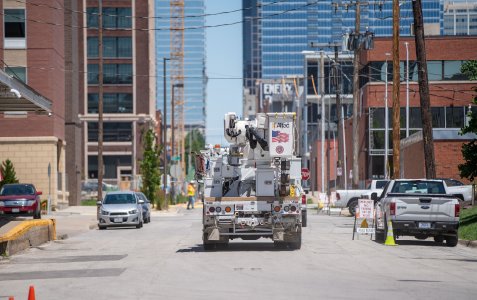 back of large Evergy work truck headed into a large city