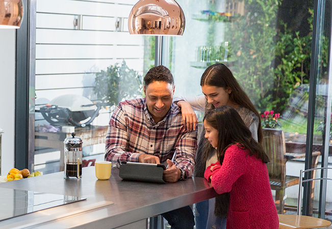 parent with kids looking at tablet