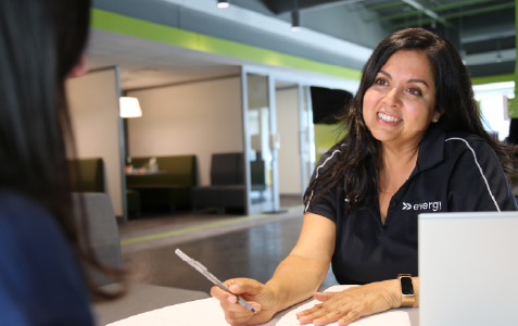 Image of a woman smiling across a desk 