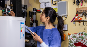 a woman adjusting a water pump
