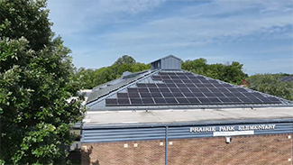 Image of a school with solar panels on the roof
